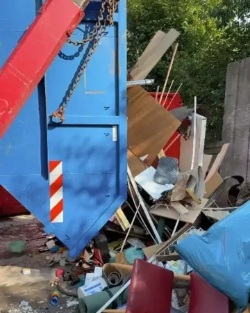 Sperrmüll und verschiedene Abfallarten neben einem Entsorgungscontainer bei einer Haushaltsauflösung